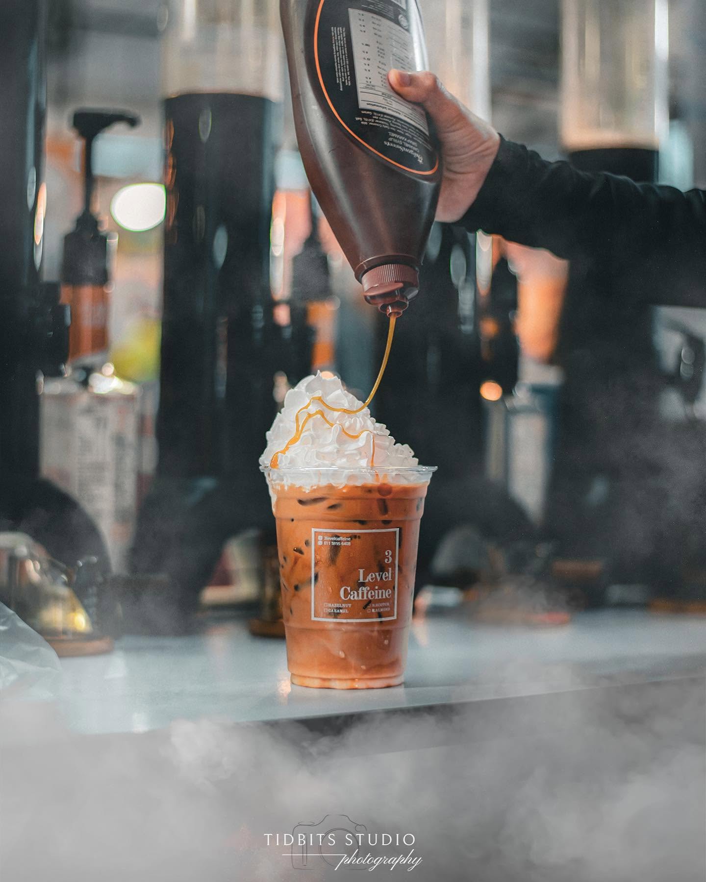Caramel drizzle falling onto whipped cream